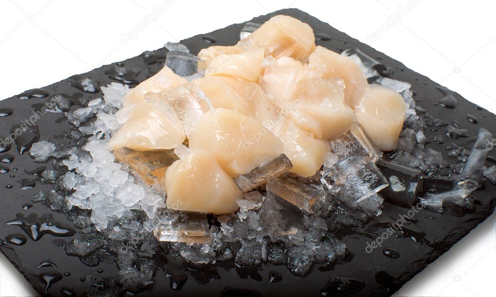 pieces of fresh fish on stone plate with ice