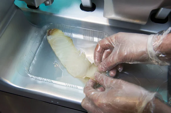 Chef cutting fish, on a slicer — Stock Photo, Image