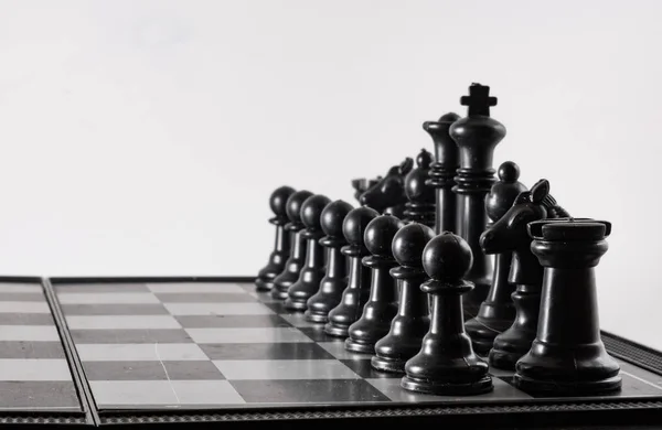 Black chess side view on a black background — Stock Photo, Image