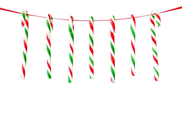 Candy Canes opknoping op lint als Kerstmis achtergrond — Stockfoto