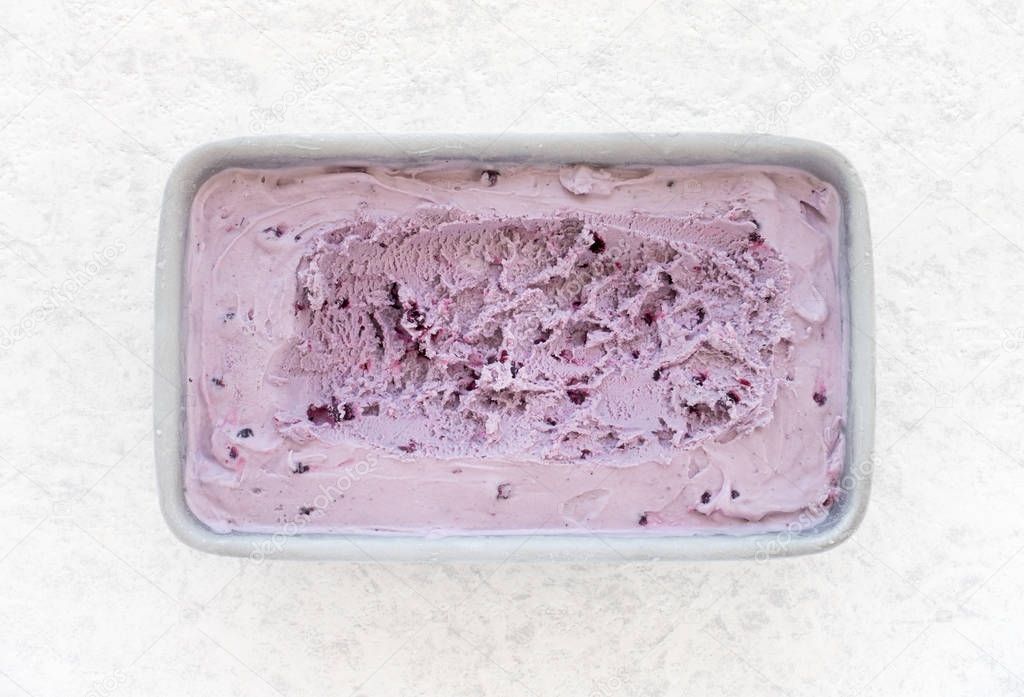 Blueberry Ice Cream in Container on White  