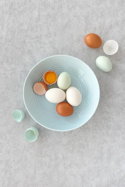 Blue, Brown and White Eggs in a Blue Bowl