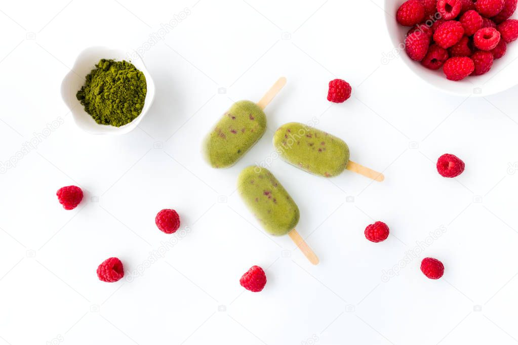 Three Matcha and Raspberry Popsicles on White Background  