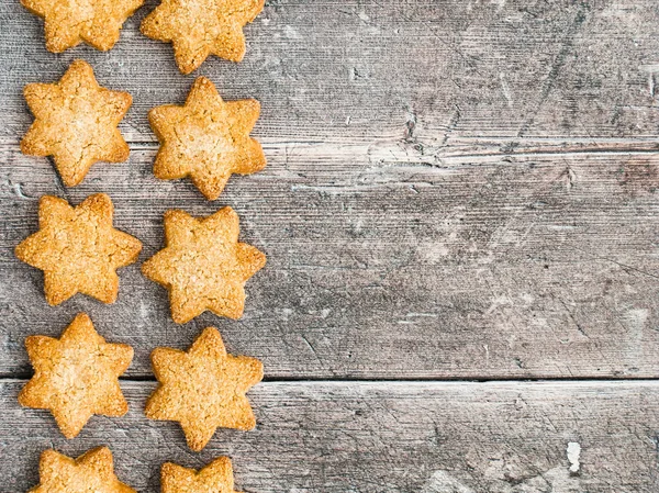 Border of Christmas Star Cookies on Rustic Wood — Stock Photo, Image