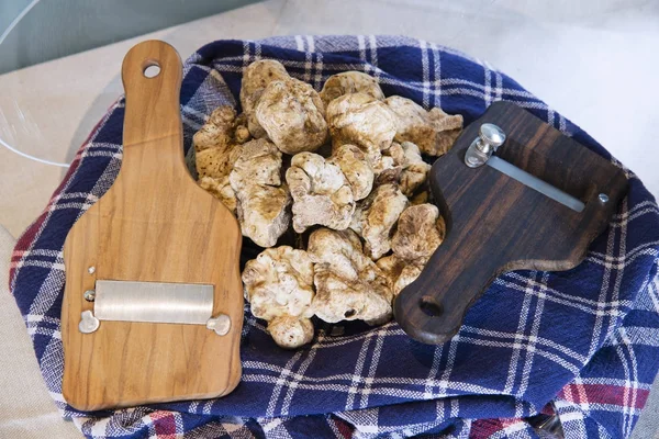 White truffles on cloth with truffle cut in wood — Stock Photo, Image