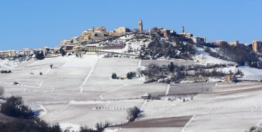 View of Langhe hills with snow and the village of La Morra Piedm clipart