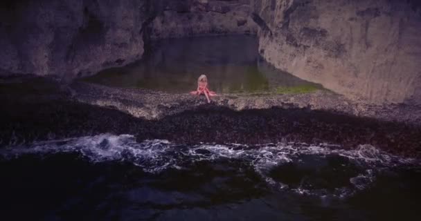 Young Woman Pink Dress Sits Alone Natural Pool View Drone — 비디오