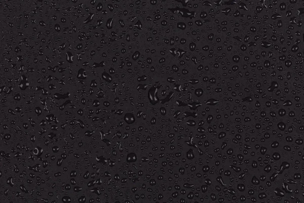 Gotas de água em pedra escura — Fotografia de Stock