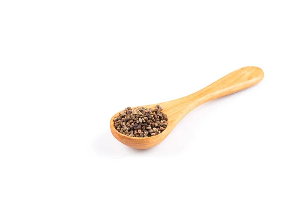 Decorticated cardamom seeds in a wooden spoon — Stock Photo, Image