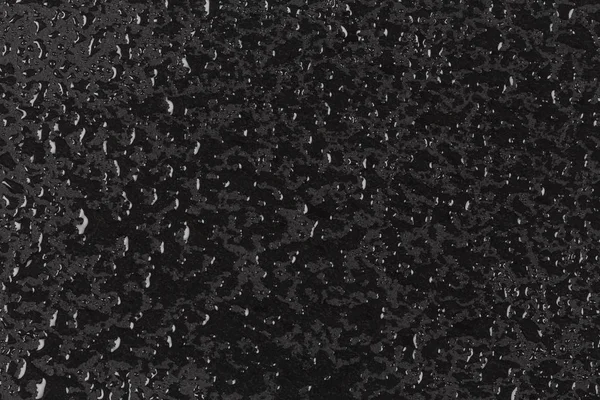 Gotas de água na superfície de pedra escura — Fotografia de Stock