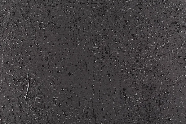 Water drops on dark stone