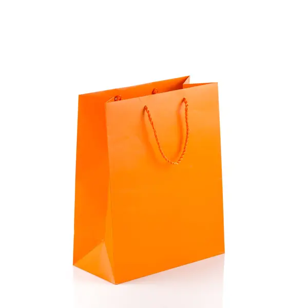 Narancssárga papírzacskót elszigetelt fehér átló szög — Stock Fotó