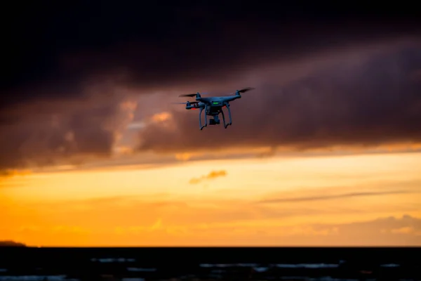 Flying drone over sea and cloud sky