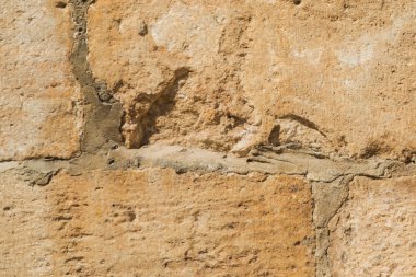 Taşlar arka plan, bloklar arka plan. Taş dokusu. Işık taşlarından duvar, yakın çekim. Bloklar arası dikişler. Sert yüzey.