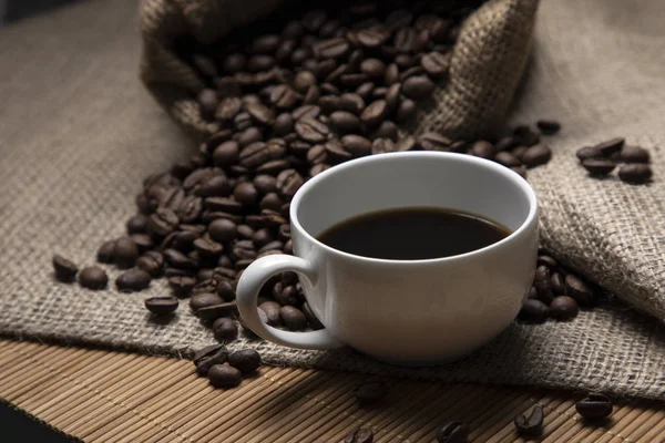 - Kahve. Turnike torbasında bir fincan espresso ve kahve çekirdeği.. 