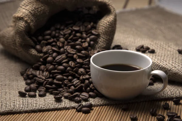 Coffee beans and a cup of freshly brewed coffee. Stock Image