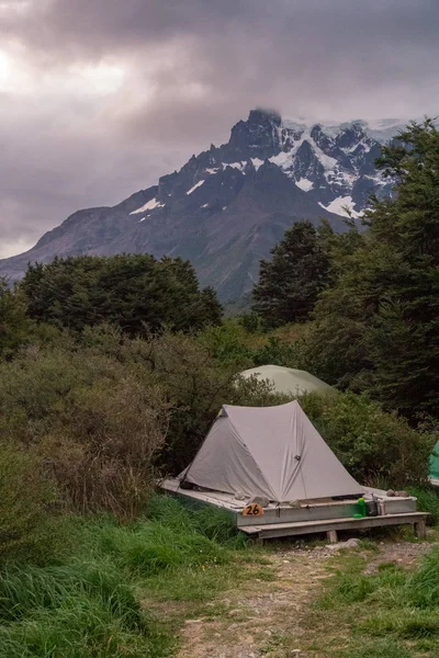 Tent pitched on platform with mountain — 스톡 사진