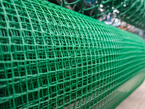 Grid for the house and a garden. Roll of a green garden plastic lattice