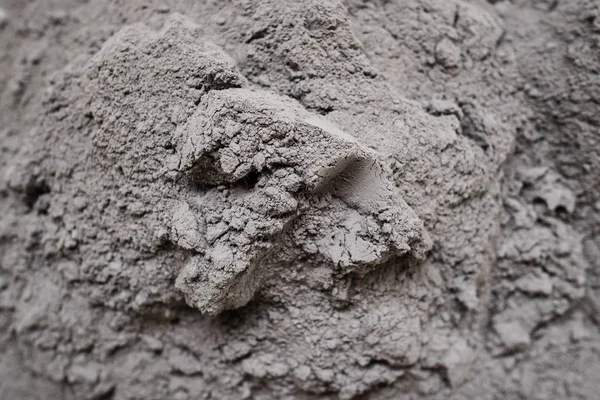 Dry cement in the form of gray powder. For repair and construction
