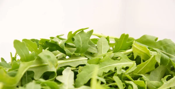 green fresh rucola leaves . Rocket salad or arugula.