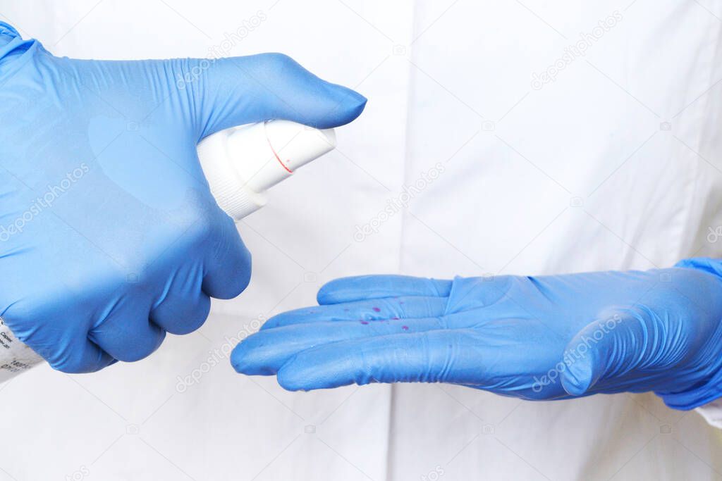 alcohol antiseptic gel and latex gloves,prevent against infection of Covid-19 outbreak,woman washing hands with hand sanitizer to avoid contaminating with Corona virus