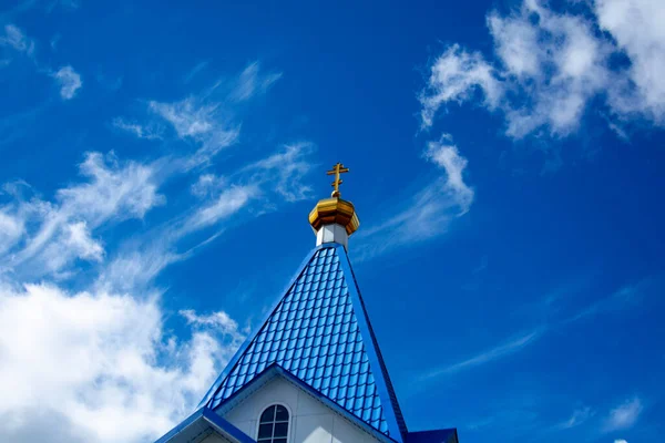 cross on a background of blue sky. The concept of faith and hope.Belarus