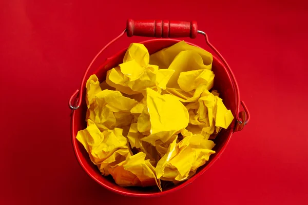 Red Metal Bucket Crumpled Yellow Paper Creativity Crisis Concept — Stock Photo, Image