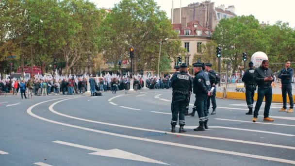 Paris, France - October, 2019: Police officers discuss security while patrolling a rally in France. — 비디오