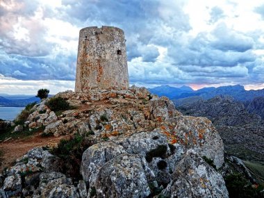 Viewpoint at Talaia d'Albercutx Peak near Mirador Es Colomer in the North Mallorca with the Blue Dark Clouds clipart