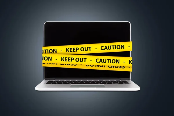 Caution and Keep Out Tapes on Laptop with Blank Screen — Stock Photo, Image