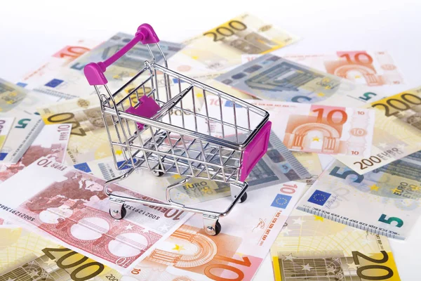 Euro Banknotes with Shopping Cart Consuming Concept Royalty Free Stock Photos