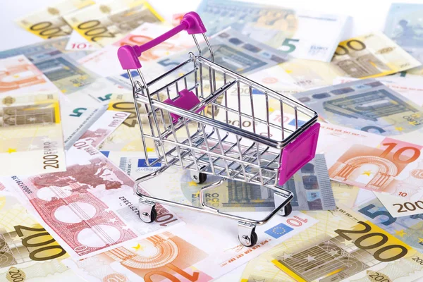 Euro Banknotes with Shopping Cart Consuming Concept Stock Image