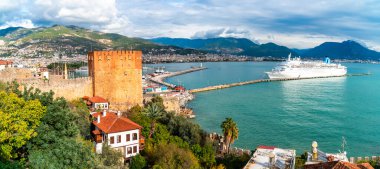 ALANYA, TURKEY - DECEMBER 26, 2019 : Landscape view of Red Tower with marina. Alanya is popular destination in south of Turkey.