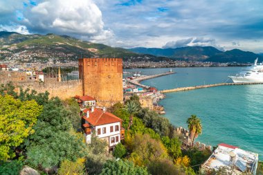 ALANYA, TURKEY - DECEMBER 26, 2019 : Landscape view of Red Tower with marina. Alanya is popular destination in south of Turkey.