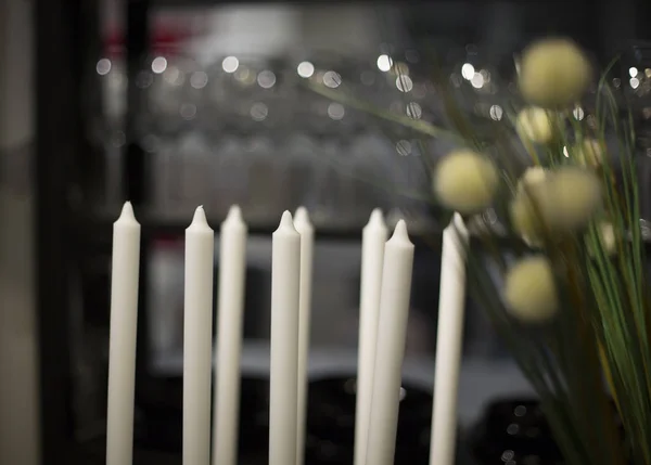 white candles without fire on a blurred background