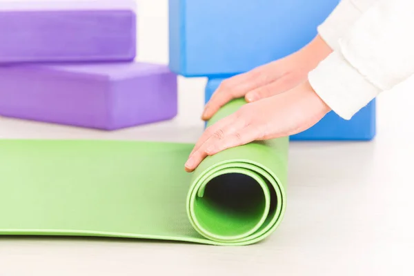 Enrolando um tapete de ioga — Fotografia de Stock