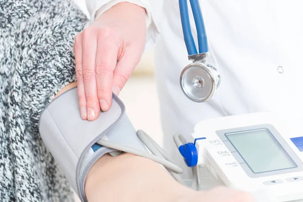 Médico que mede a pressão arterial — Fotografia de Stock