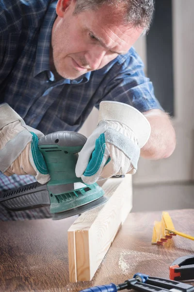 Man sanding a wood with orbital sander — Stock Image Man sanding a wood with orbital sander Stock Picture