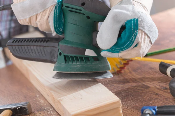 Man sanding a wood with orbital sander — Stock Image Man sanding a wood with orbital sander Royalty Free Stock Images