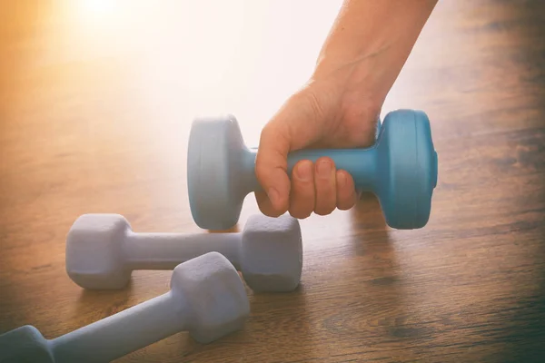 Woman's hand with dumb-bells — Stock Photo, Image