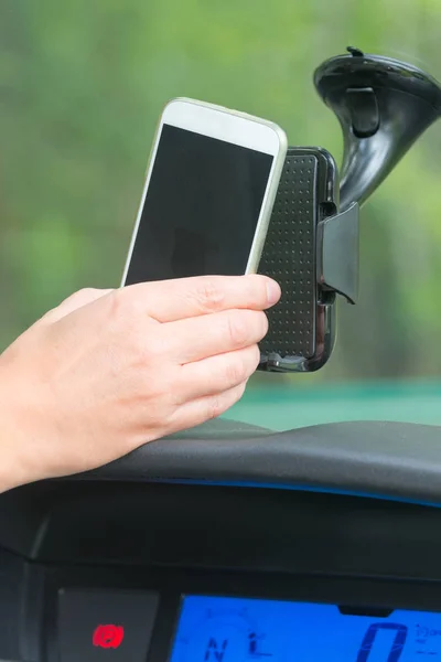 Inserting smart phone into the car holder — Stock Photo, Image