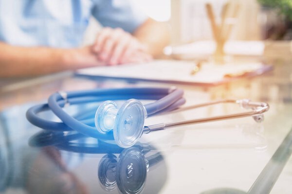 Close up of stethoscope and doctor