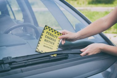 Parking ticket under windshield wiper clipart