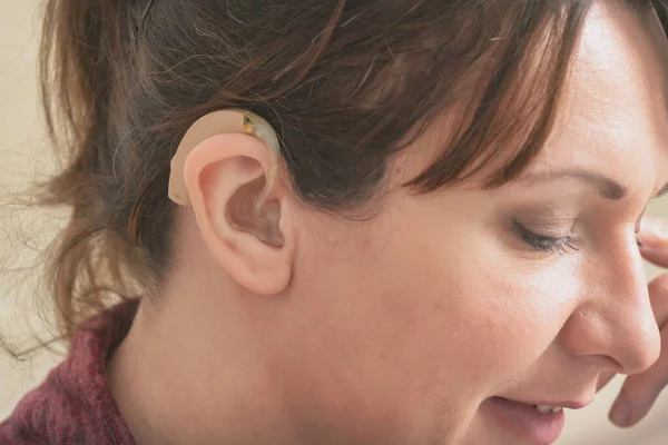 Hearing impaired woman wearing hearing aid