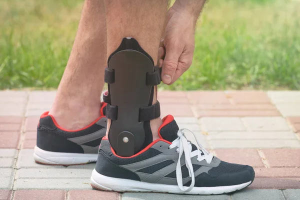 Man Athletic Sneakers Wearing Ankle Orthosis Brace — Stock Photo, Image