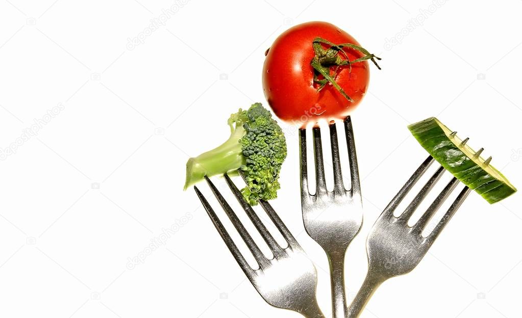tomato with fork one a table