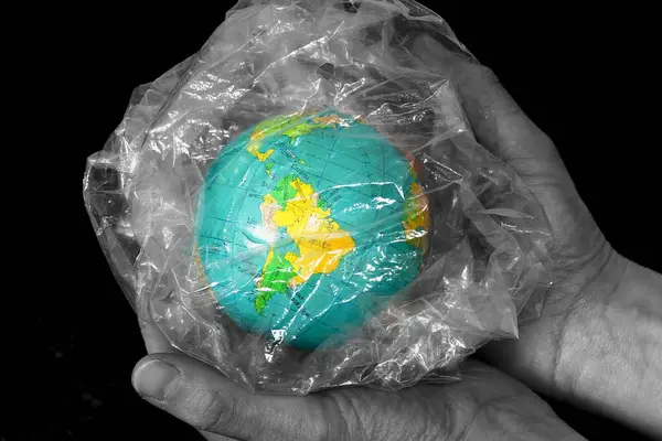 planet earth trapped in plastic bag waste stock image with black background