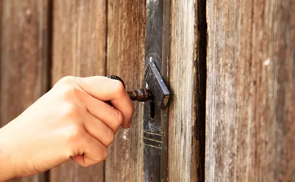 locking a big gate to a property with people
