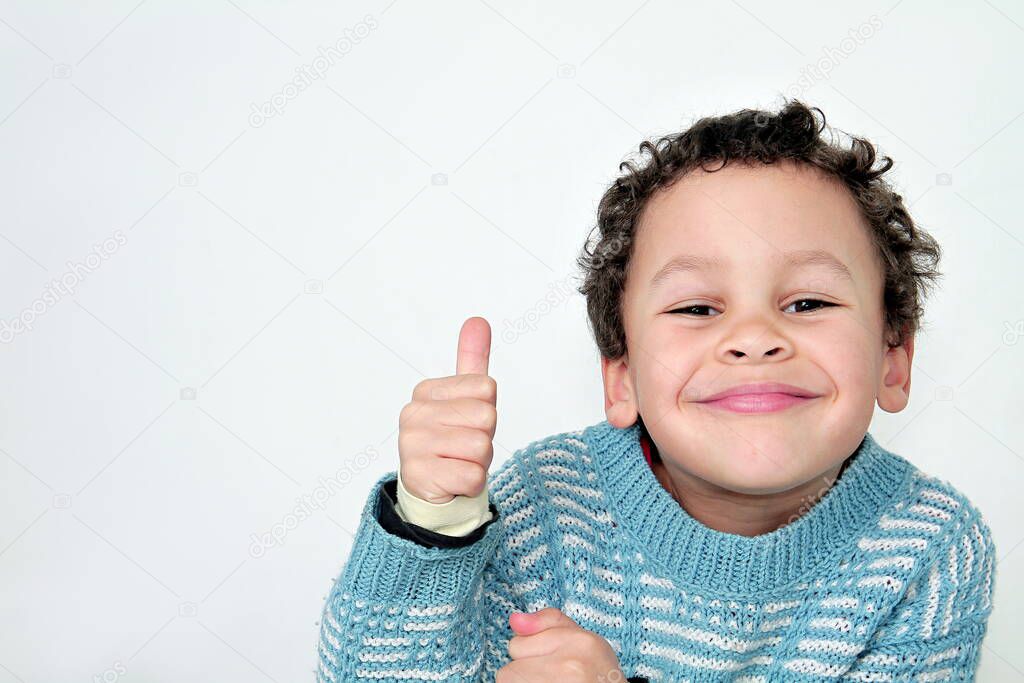 little boy showing thumbs up on white background stock photo