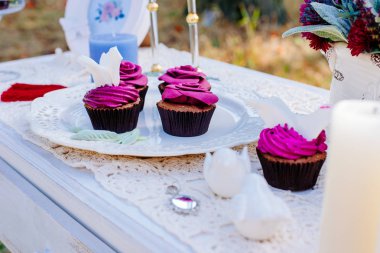 Cupcakes in the form of flowers. Wedding decoration on nature